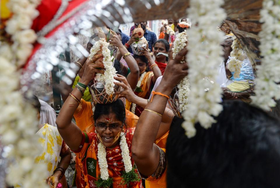 Hindu devotees carry milk pots as offerings during "Aadi Kiruthigai" celebrations (dedicated to the Lord Muruga) at Vadapazhni Murugan temple in Chennai on July 26, 2019. - Aadi is considered a holy month by Tamils and is celebrated with rituals to worship Hindu gods. (Photo by ARUN SANKAR / AFP)        (Photo credit should read ARUN SANKAR/AFP via Getty Images)