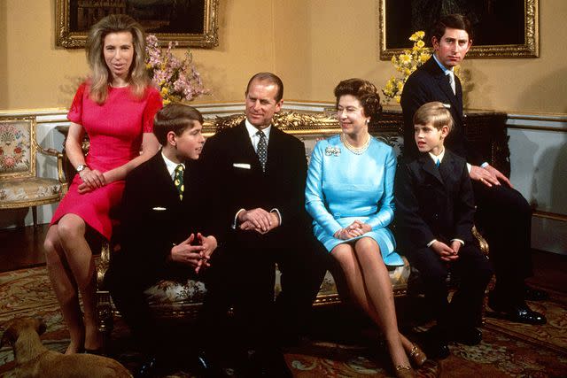 <p>Fox Photos/Hulton Archive/Getty Images</p> Princess Anne, Prince Andrew, Prince Philip, Queen Elizabeth, Prince Edward and Prince Charles at Buckingham Palace in 1972.