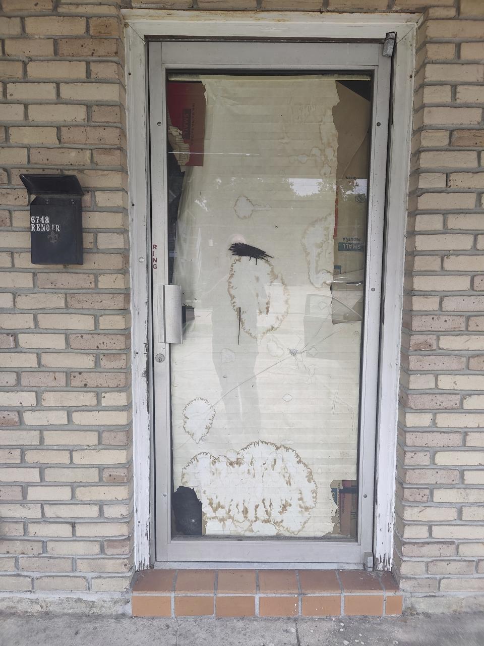 A broken glass door sits in the entrance of the unapproved school named Second Chance Academy, in Baton Rouge, La., June 19, 2023. The school has come under scrutiny since its head teacher was arrested on charges of sexually abusing students. (Charles Lussier/The Advocate via AP)
