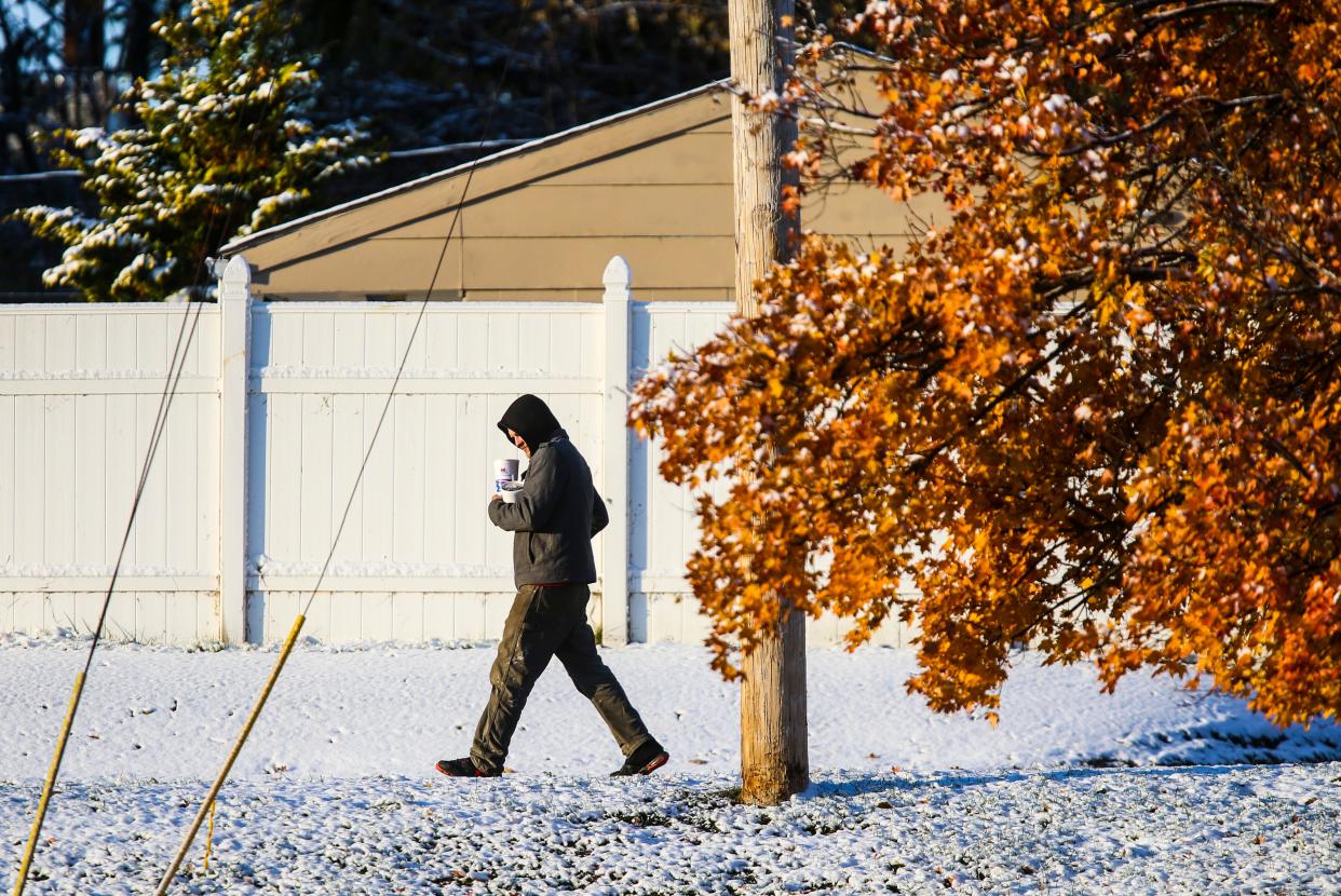 The first snow fall of the year contrasted with the golden hues of this tree that still clung its leaves in New Albany. Cold weather hit the area Tuesday morning as temperatures were in the teens. Nov. 12, 2019