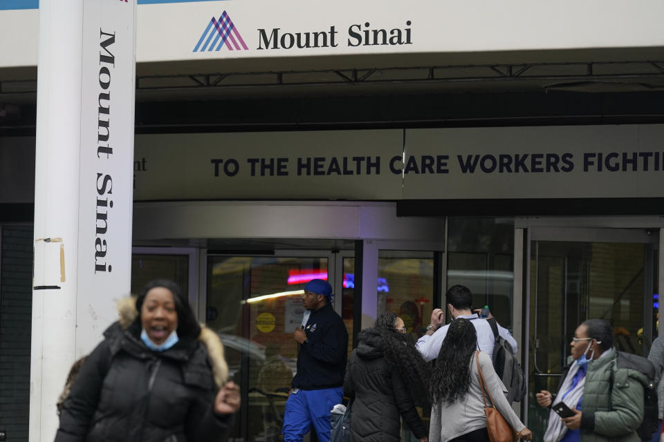 People walks near an entrance of Mount Sinai Hospital in New York, Thursday, Jan. 12, 2023. Two New York City hospitals have reached a tentative contract agreement with thousands of striking nurses that ends the walkout, the nurses' union announced today. (AP Photo/Seth Wenig)