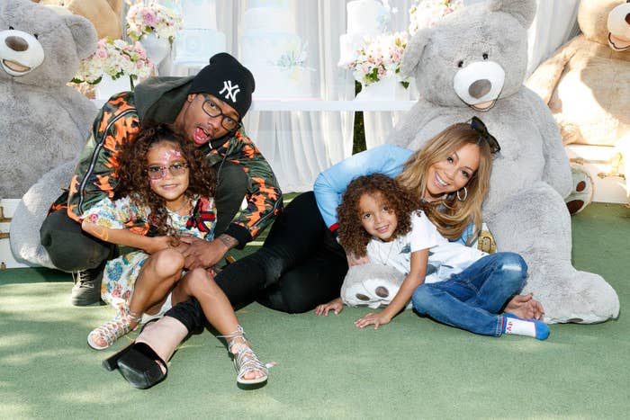 Nick Cannon posing for a photo with Mariah Carey and their twins