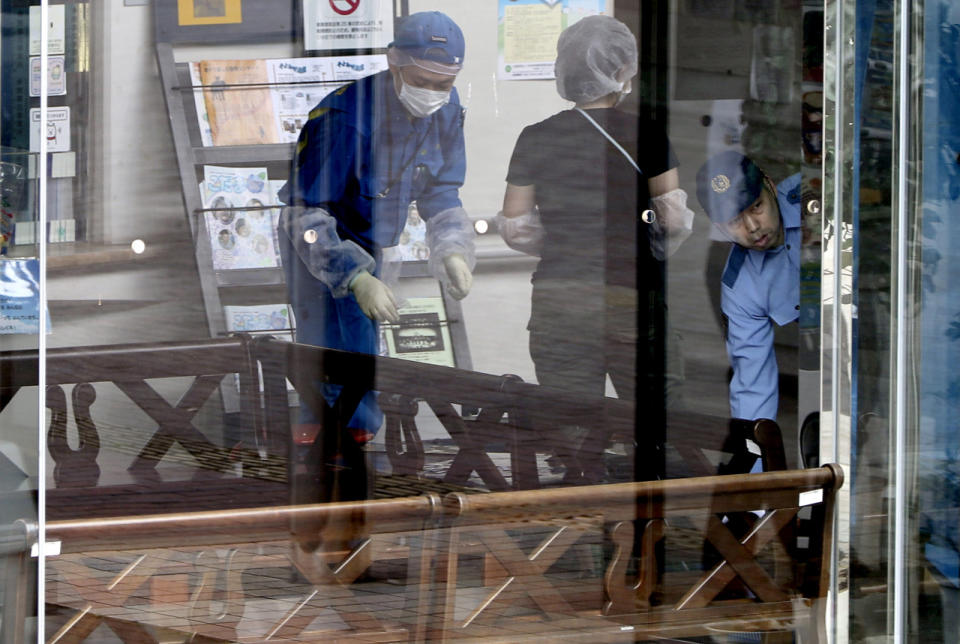 <p>Police investigators check the Tsukui Yamayuri-en, a facility for the mentally disabled where a number of people were killed and dozens injured in a knife attack in Sagamihara, outside Tokyo Tuesday, July 26, 2016. (AP Photo/Eugene Hoshiko)</p>