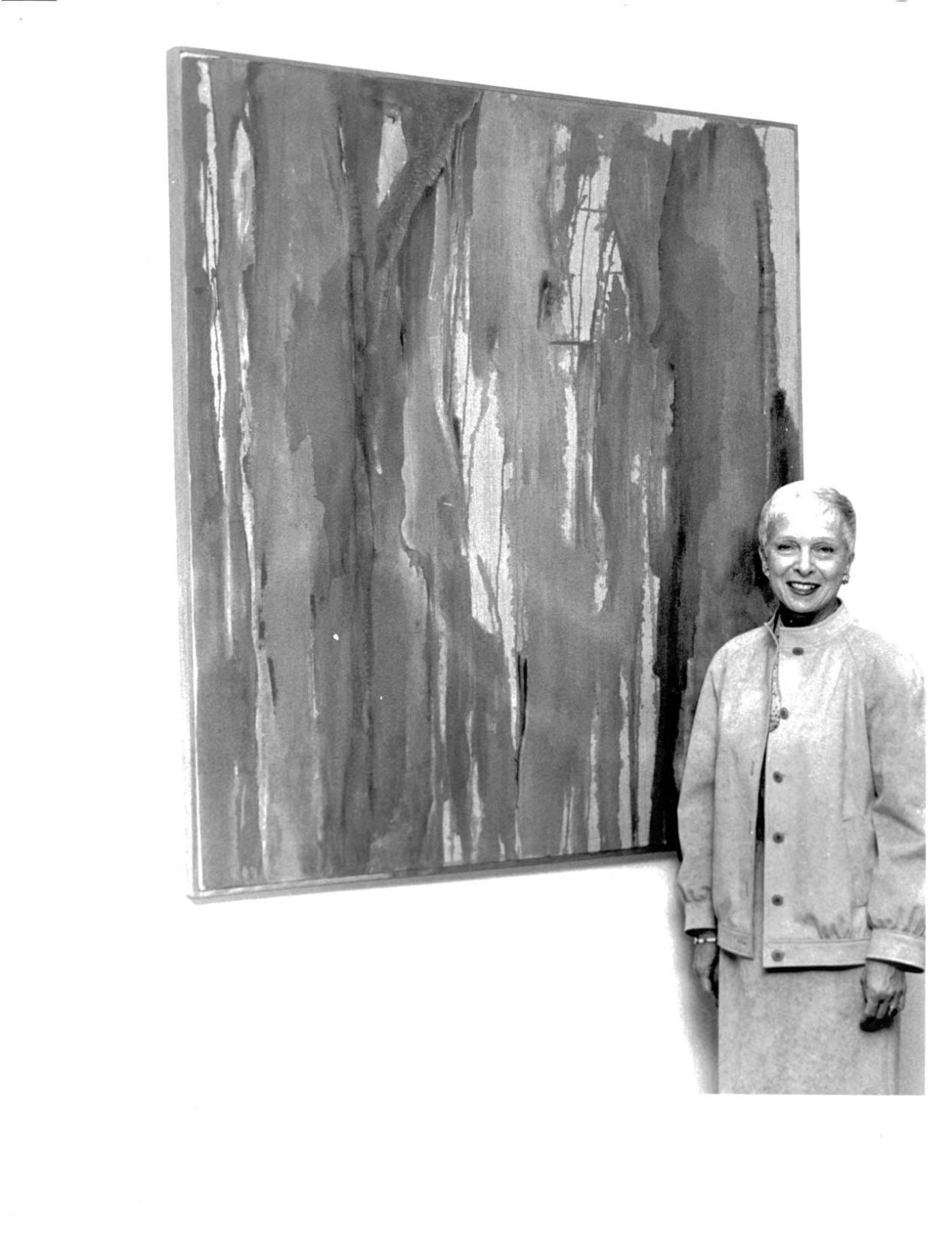 In this file photo from May 13, 1982, Ernestine M. Raclin poses by a work of art at 1st Source Bank in South Bend. The philanthropist and former chair of 1st Source Bank and 1st Source Corporation died July 13, 2023, at the age of 95.