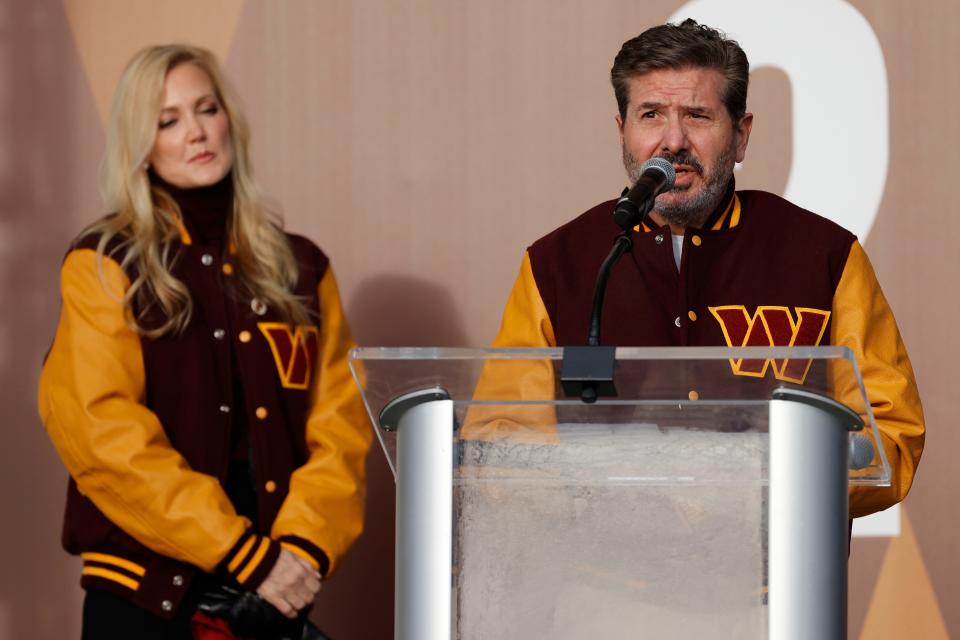 Washington Commanders co-owner Dan Snyder speaks as co-owner Tanya Snyder (L) listens during a press conference revealing the Commanders as the new name for the formerly named Washington Football Team at FedEx Field.