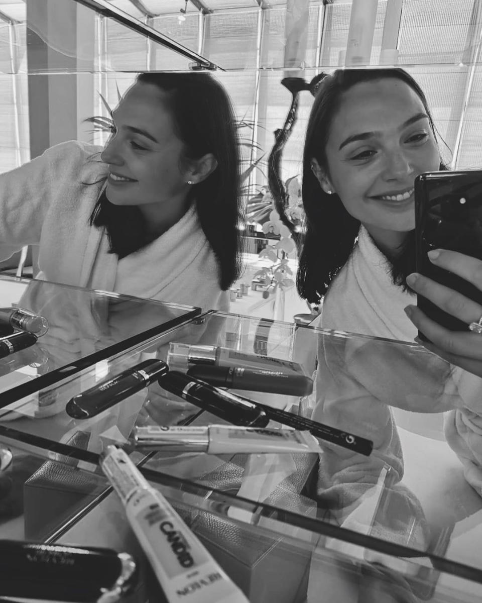 Gal Gadot takes a selfie in a bathrobe