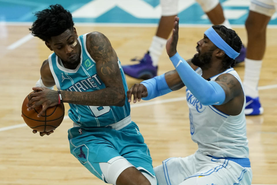 Charlotte Hornets forward Jalen McDaniels, left, fouls Los Angeles Lakers guard Wesley Matthews during the second half in an NBA basketball game on Tuesday, April 13, 2021, in Charlotte, N.C. (AP Photo/Chris Carlson)