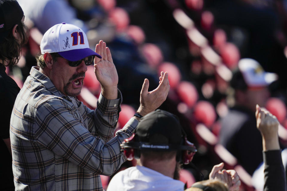 A fan applauds after a qualifying heat ahead of a NASCAR exhibition auto race at Los Angeles Memorial Coliseum, Sunday, Feb. 5, 2023, in Los Angeles. (AP Photo/Ashley Landis)