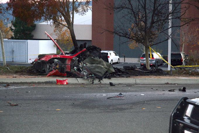 In this Nov. 30, 2013 photo released by the Los Angeles County Sheriff Department on Tuesday, March 25, 2014, shows the wreckage of a Porsche that crashed into a light pole in Valencia, Calif. Crash investigators have determined that the car carrying "Fast & Furious" star Paul Walker was traveling approximately 90 mph when it lost control on a city street and smashed into a light pole, killing the actor and his friend Roger Rodas. A person who has reviewed the investigators’ report told The Associated Press that it concluded unsafe driving, not mechanical problems, caused the crash. The person requested anonymity because the report has not been officially released yet. (AP Photo/Los Angeles County Sheriff)