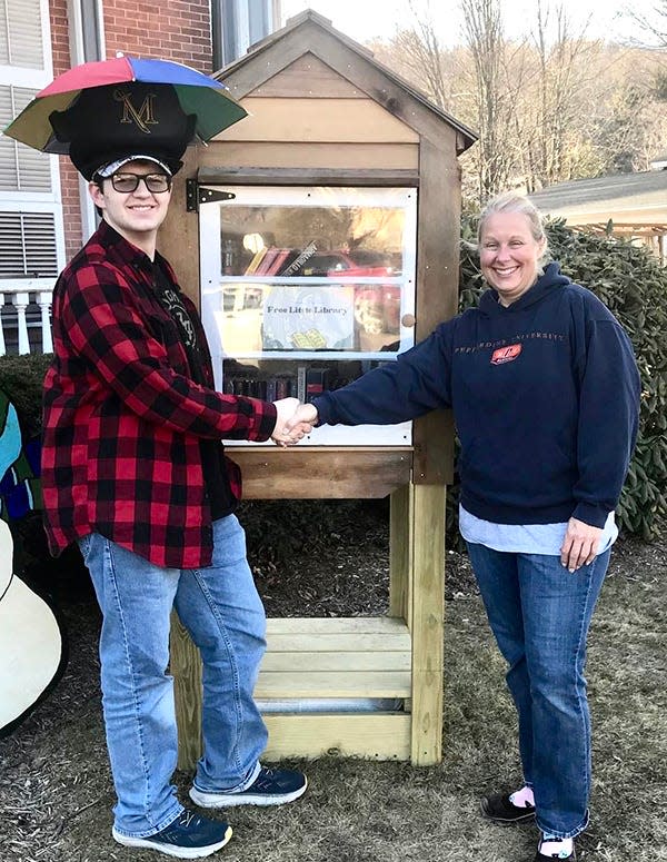 Tracy Schwarz, Executive Director of the Wayne Library Alliance, congratulates Brodie Cole on the completion of his Eagle Scout project, a "Little Free Library" that's been installed on the front lawn of the Wayne County Public Library in Honesdale.