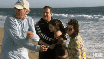 GIF of a woman throwing Larry David's phone in the ocean in "Curb Your Enthusiasm"