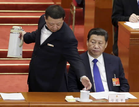 Chinese President Xi Jinping is served by an attendant during the opening of the annual full session of the National People's Congress, the country's parliament, at the Great Hall of the People, in Beijing, in this March 5, 2015 file photo. REUTERS/Jason Lee/Files