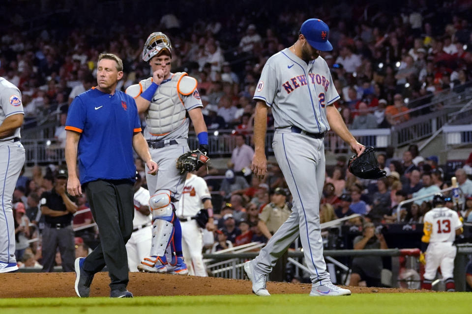 New York Mets starting pitcher David Peterson (23) leaves the mound after being injured during the fourth inning of the team's baseball game against the Atlanta Braves on Wednesday, June 30, 2021, in Atlanta. (AP Photo/John Bazemore)