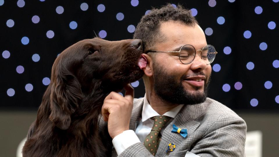 Baxer, a Flat Coat Retriever, seen with owner Patrick Oware after taking home the coveted title Crufts Best in Show champion at National Exhibition Centre on March 13, 2022 in Birmingham