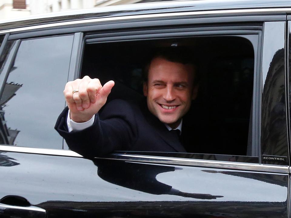 Emmanuel Macron, head of the political movement En Marche !, or Onwards !, and candidate for the 2017 presidential election, waves from his car as he leaves his home during the second round of the election, in Paris, France, May 7, 2017.
