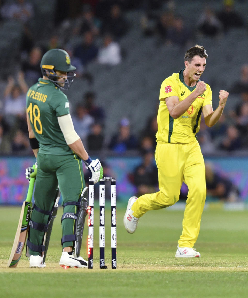 Patrick Cummins of Australia, right, celebrates the dismissal of Faf du Plessis, left, of South Africa during their second One-Day International cricket match in Adelaide, Friday, Nov. 9, 2018. (David Mariuz/AAP Image via AP)