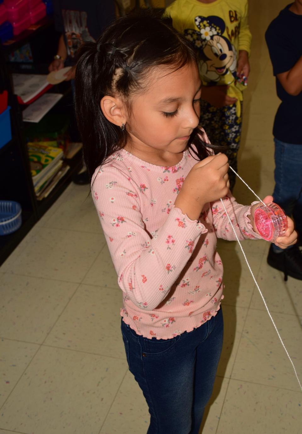Leah, a student at Inter-Faith Community Preschool, winds up a yo-yo at the north Fort Smith preschool that will close May 17 after 56 years.
