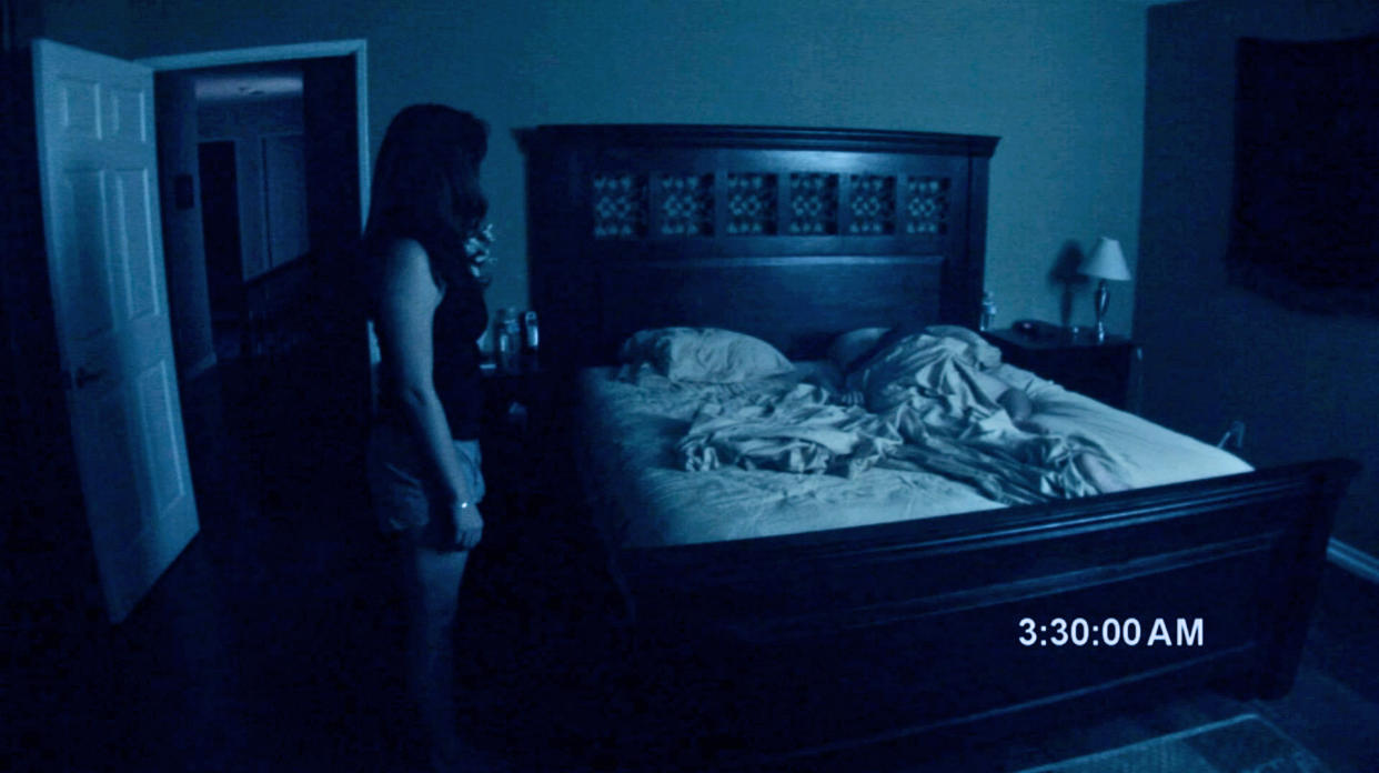 Katie stands over Micah in an eerie scene from Paranormal Activity. (Photo: Paramount Pictures/Courtesy Everett Collection)