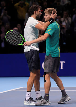 Tennis - ATP World Tour Finals - The O2 Arena, London, Britain - November 19, 2017 Bulgaria's Grigor Dimitrov with Belgium's David Goffin after winning the final REUTERS/Toby Melville