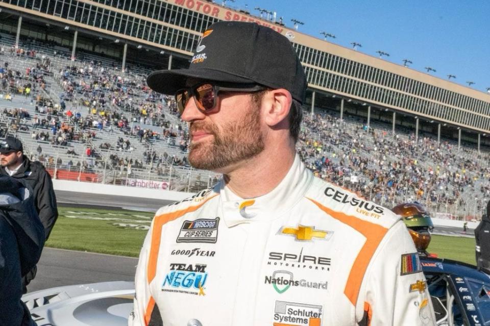 Corey LaJoie stands on pit road after finishing fourth at Atlanta