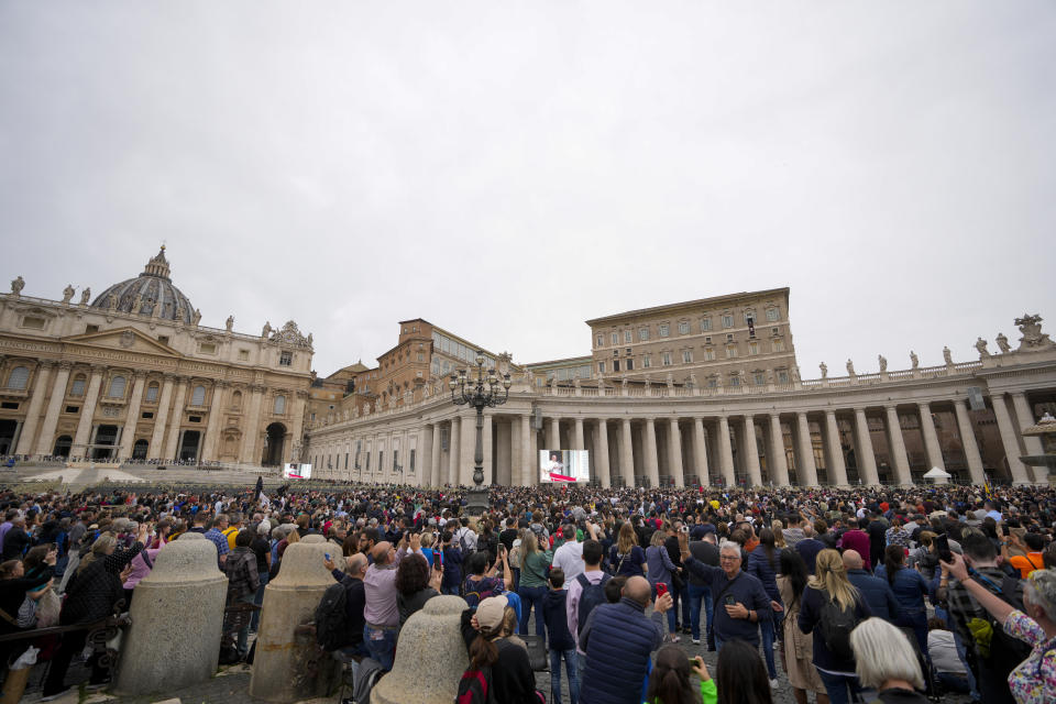 People gather as Pope Francis delivers his blessing as he recites the Angelus noon prayer from the window of his studio overlooking St.Peter's Square, at the Vatican, on the occasion of All Saints Day, Wednesday, Nov. 1, 2023. (AP Photo/Andrew Medichini)