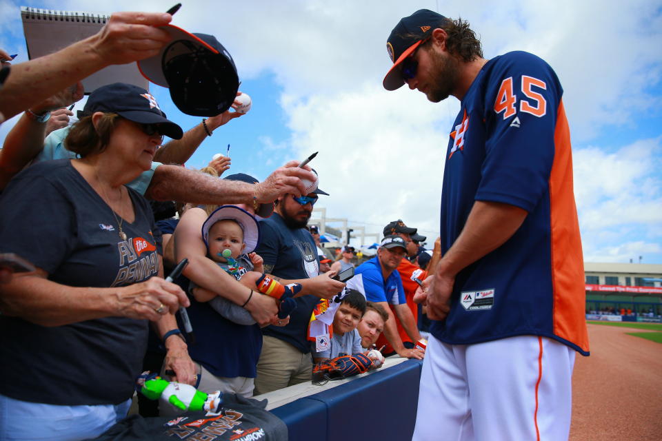 <p>Houston Astros pitcher Gerritt Cole signs for fans before the baseball game against the Minnesota Twins at the Ballpark of the Palm Beaches in West Palm Beach, Fla., on Feb. 28, 2018. (Photo: Gordon Donovan/Yahoo News) </p>