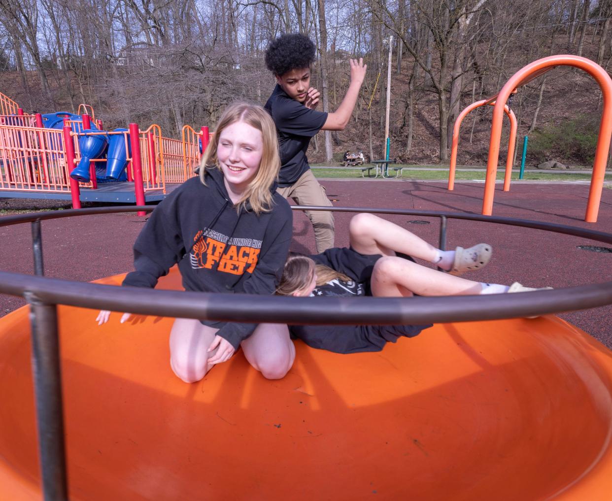 Gino Milini spins Shyanne Snyder, 12, left, and Hailey Feenaughty, 12,on the merry-go-round Monday, April 8, 2024, at Massillon's Reservoir Park.