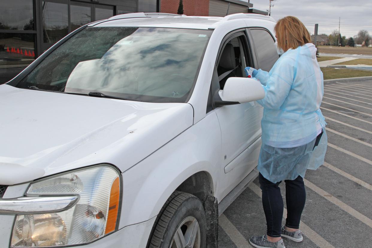 Abby Berndt, RN, of Community Health Services, prepares to administer a Covid-19 test Friday. Dozens of local residents turned up at Community Health Services' main office, as the organization offered COVID-19 drive-thru testing at its Hayes Avenue site.