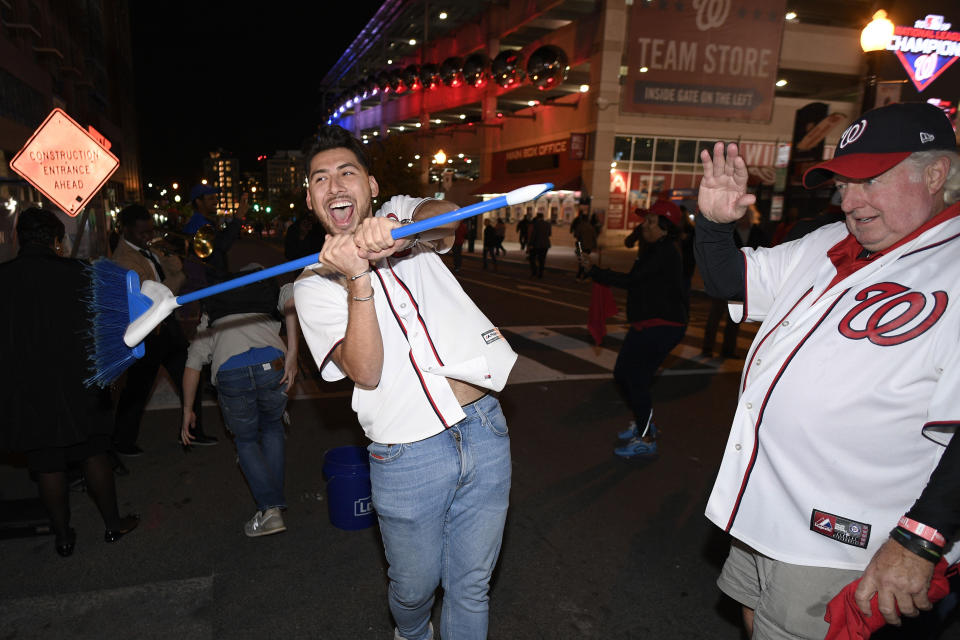 Washington Nationals fans celebrate after the Nationals swept the St. Louis Cardinals in the baseball National League Championship Series, Tuesday, Oct. 15, 2019, in Washington. The Nationals won Tuesday's game 7-4. (AP Photo/Nick Wass)