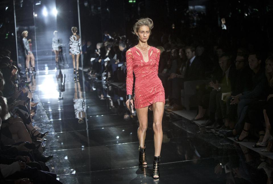 A model wears a design created by Tom Ford during London Fashion Week Spring/Summer 2014, at Lindley Hall, central London, Monday, Sept. 16, 2013. (Photo by Joel Ryan/Invision/AP)