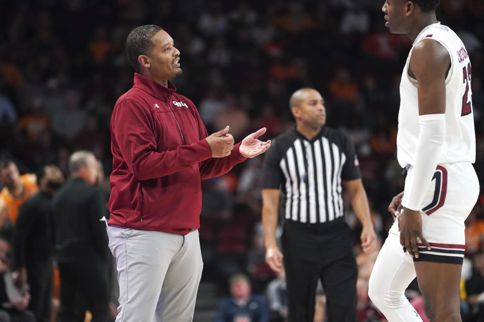 South Carolina head coach Lamont Paris, left, speaks with Gregory Jackson II (23) during the first half of an NCAA college basketball game against Tennessee, Saturday, Jan. 7, 2023, in Columbia, S.C. (AP Photo/Sean Rayford)