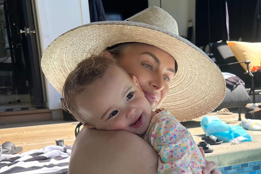 Lala and Ocean hugging in a pool.