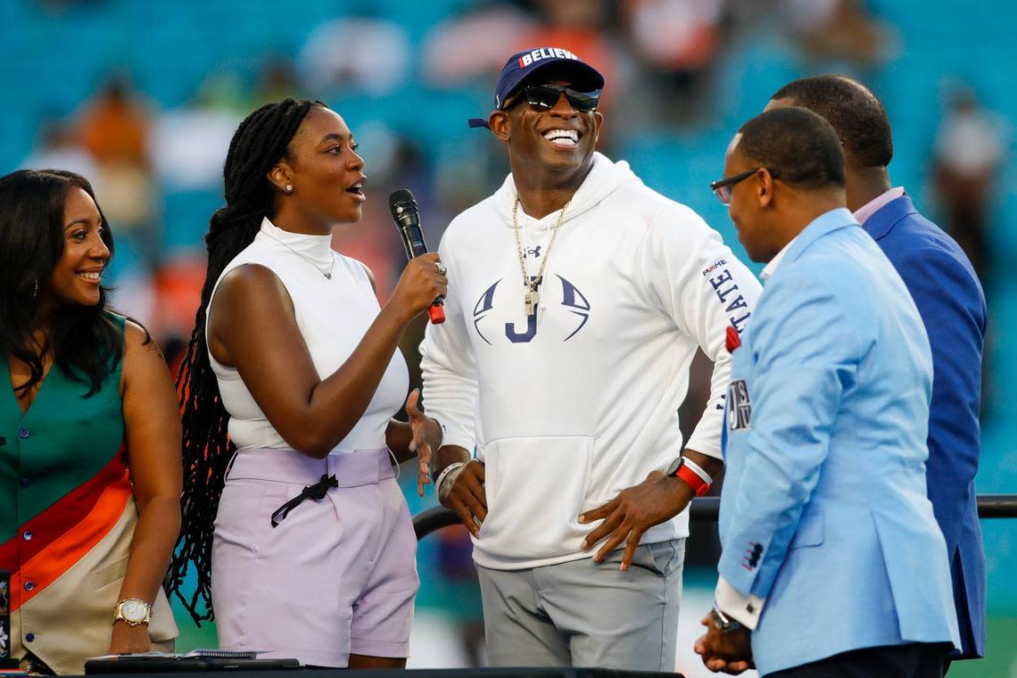 Jackson State Tigers head coach Deion Sanders, center, smiles while being interviewed after winning the Orange Blossom Classic against the Florida A&M Rattlers at Hard Rock Stadium in Miami Gardens, Florida, Sunday, September 4, 2022.