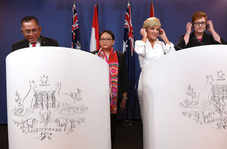 Indonesia's Defence Minister Ryamizard Ryacudu and Foreign Minister Retno Marsudi stand with Australia's Foreign Minister Julie Bishop and Defence Minister Marise Payne during a media conference after their bilateral meeting in Sydney, Australia, March 16, 2018. William West/Pool via REUTERS