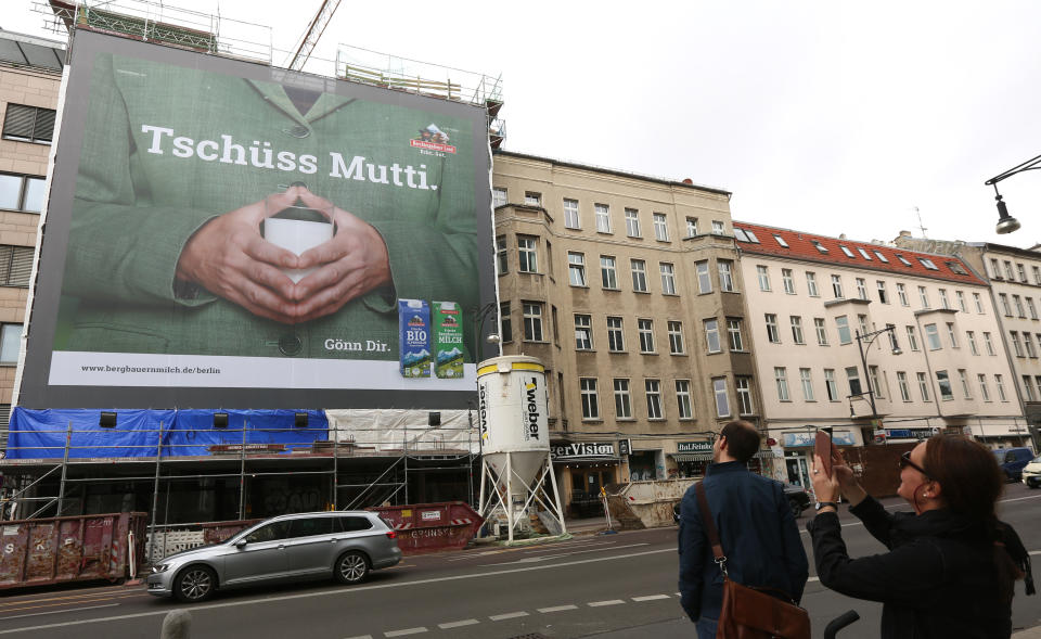 BERLIN, GERMANY - SEPTEMBER 12: An advertisement for a milk company shows German Chancellor Angela Merkel's trademark hand pose holding a glass of milk with the words 