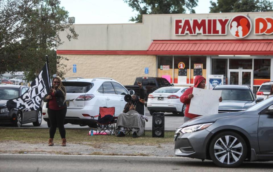 Marquell Bridges, center, chants “Hands up, Don’t Shoot” outside of Family Dollar on Pass Road in Gulfport, where he and others have been protesting for justice in the police killing of 15-year-old Jaheim McMillan.