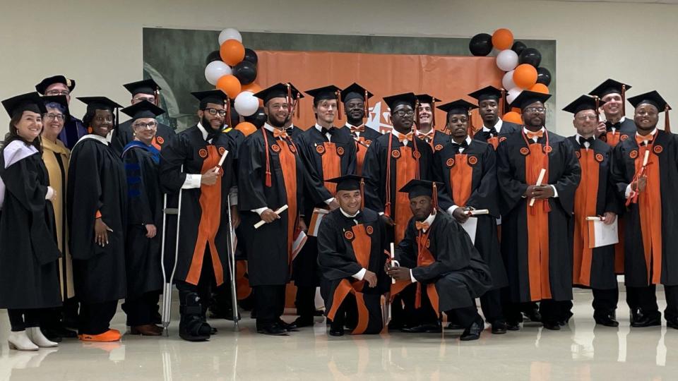 New graduates of Campbell University pose with Campbell faculty after a commencement ceremony held on Thursday, Nov. 2, 2023 at Scotland Correctional Institution. The graduates are inmates at Sampson Correctional Institution and are part of the Second Chance Initiative, sponsored by the Bob Barker Foundation and operated by the Campbell and N.C. Dept. of Adult Correction.