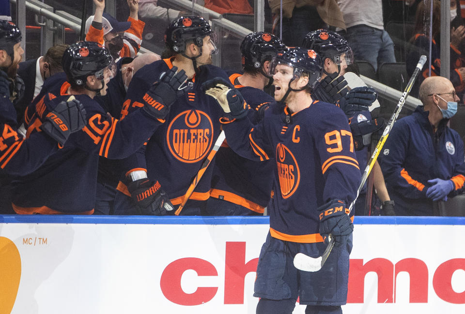 Edmonton Oilers' Connor McDavid (97) is congratulated for goal against the Calgary Flames during the first period of an NHL hockey game Saturday, Oct. 16, 2021, in Edmonton, Alberta. (Jason Franson/The Canadian Press via AP)