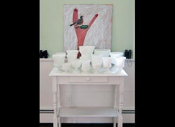 Rosen collected several milk glass vessels that each have a Neoclassical shape.  She painted a small table white to complete the color story for this vignette. 