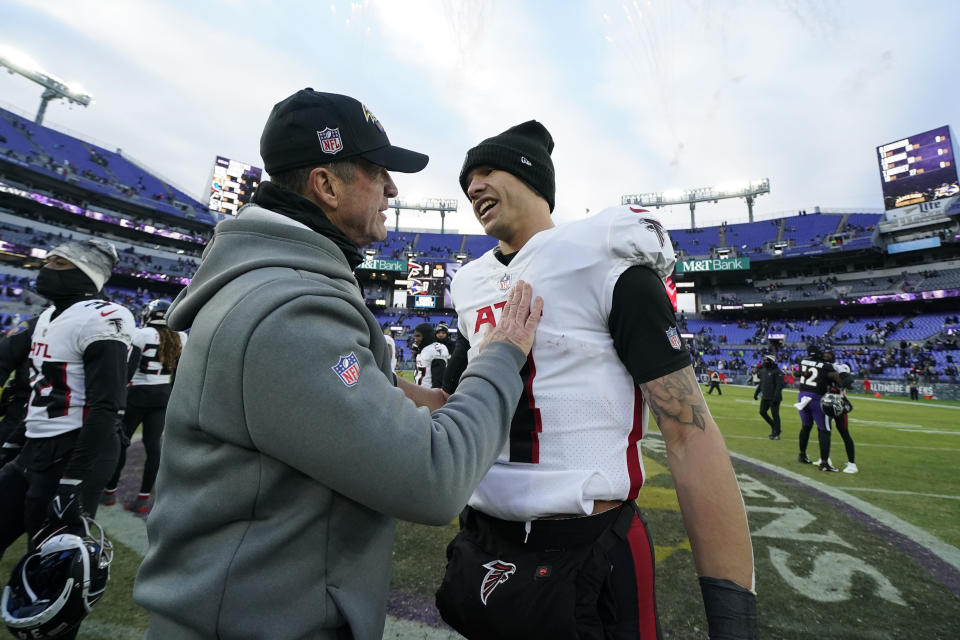 Baltimore Ravens head coach John Harbaugh greets Atlanta Falcons quarterback Desmond Ridder after an NFL football game, Saturday, Dec. 24, 2022, in Baltimore. The Ravens won 17-9. (AP Photo/Julio Cortez)