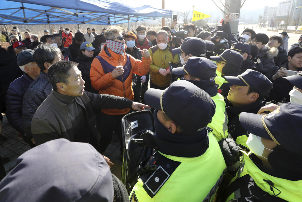 Residents stage a rally to protest the government's decision to quarantine South Koreans returning from Wuhan in their home town in Jincheon, South Korea, Thursday, Jan. 30, 2020. The death toll rose to 170 in the new virus outbreak in China on Thursday as foreign evacuees from the worst-hit region begin returning home under close observation and world health officials expressed "great concern" that the disease is starting to spread between people outside of China. (Lee Yong-hwan/Newsis via AP)