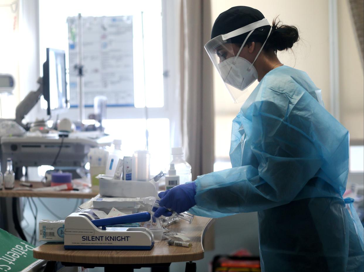 <p>Alisha Thiebert cares for Covid-19 patients in a makeshift ICU at Harbor-UCLA Medical Center on 21 January, 2021 </p> (Getty Images)