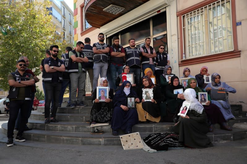 Mothers hold pictures of their children who joined the PKK militant group, during a sit-in protest outside the local headquarters of Pro-Kurdish HDP in Diyarbakir