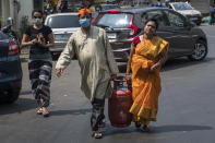 MUMBAI, INDIA - MARCH 23: People carry gas cylinder during lockdown due to Covid 19 pandemic at Walkeshwar, on March 23, 2020 in Mumbai, India. (Photo by Pratik Chorge/Hindustan Times via Getty Images)