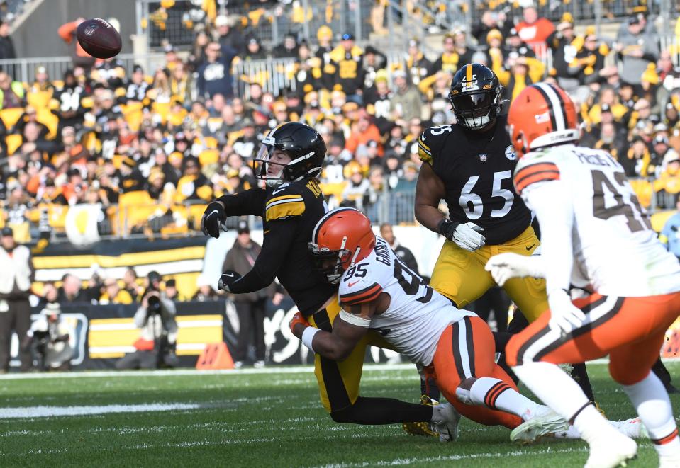 Pittsburgh Steelers quarterback Kenny Pickett (8) releases the ball as he is hit by Cleveland Browns defensive end Myles Garrett (95) on Jan. 8 in Pittsburgh.