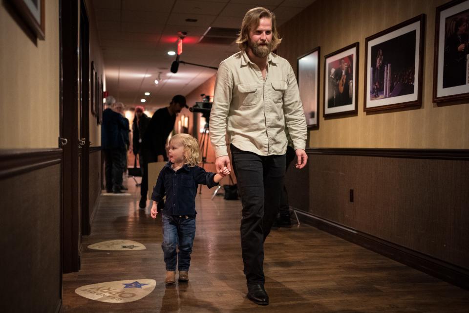 Charles Wesley Godwin walks with his son Gabriel, 3, before his Opry debut in Nashville.