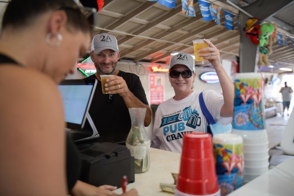 Roy and Lisa Jackson grab drinks from the Roadhouse Beer Garden as they participate in the first annual Kansas State Fair Pub Crawl.