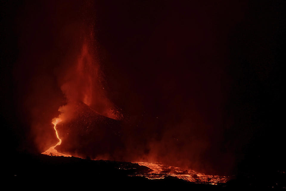 Lava spews from a volcano on the Canary island of La Palma, Spain in the early hours of Saturday Sept. 25, 2021. A volcano in Spain's Canary Islands is keeping nerves on edge several days since it erupted, producing loud explosions, a huge ash cloud and cracking open a new fissure that spewed out more fiery molten rock. The prompt evacuations are credited with helping avoid casualties but scientists say the lava flows could last for weeks or months. (AP Photo/Daniel Roca)