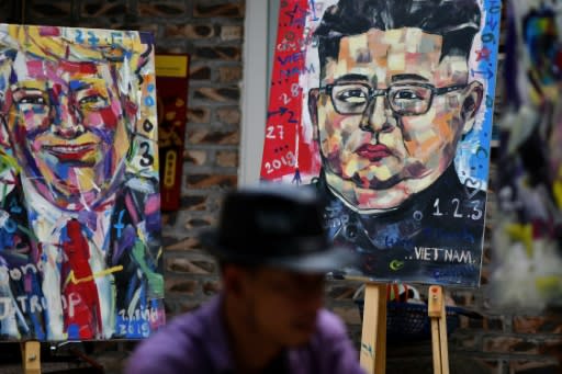 Painter Tran Lam Binh works on portraits of Donald Trump and Kim Jong Un at a Hanoi cafe ahead of their summit