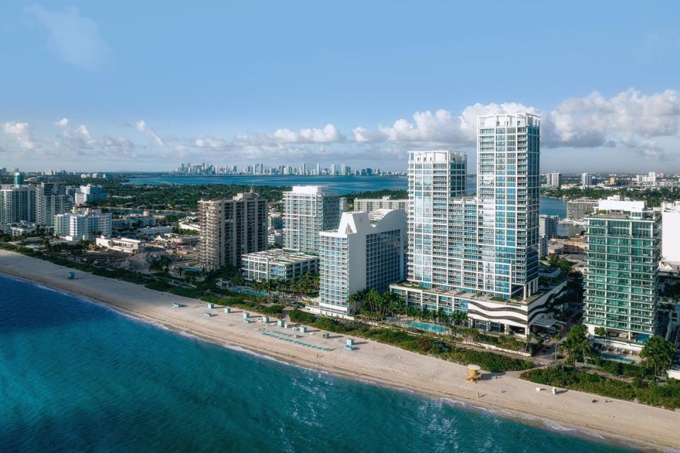 a beach with tall buildings along it